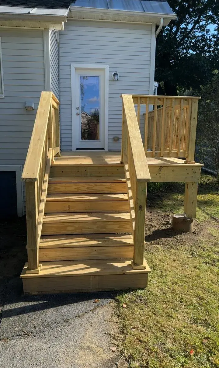 New pressure treated deck with stairs and railings built by Robson Handyman
